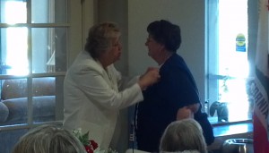 Tent President Joy Huskey (R) receives her badge of office from National President Carole Morton